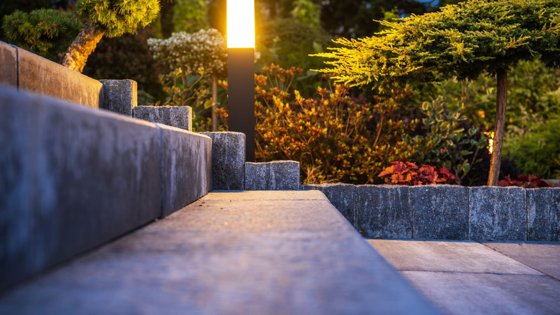 Stone steps in garden with sunset light and colorful foliage backdrop
